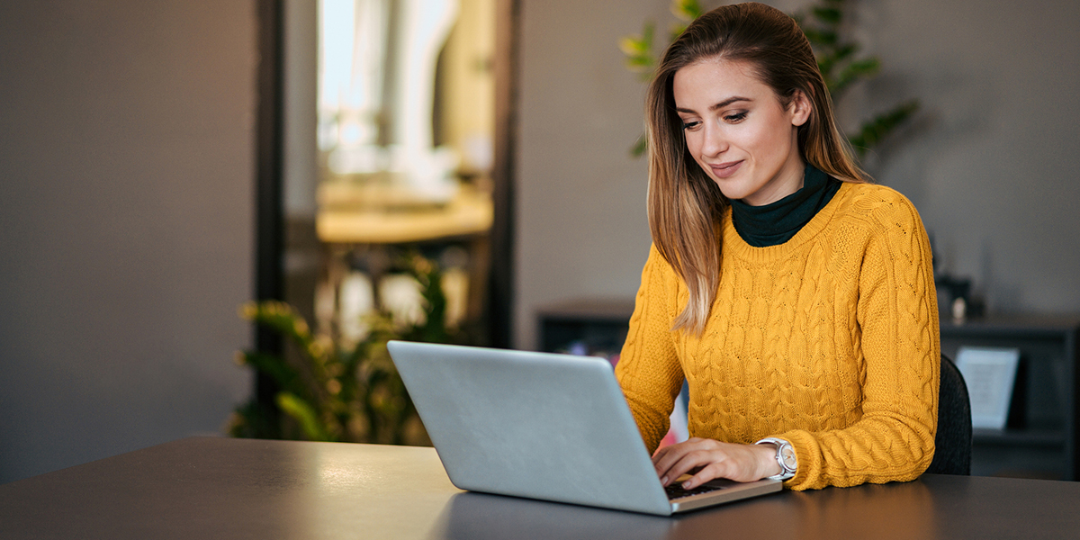 Woman Review Cloud Based Utility Billing Software On A Laptop